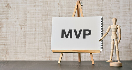 There is notebook with the word MVP. It is an abbreviation for Minimum Viable Product as...