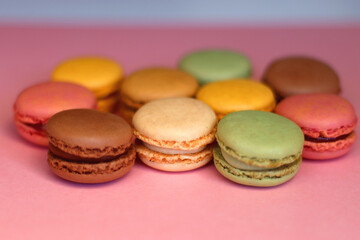Colorful macarons on pink background. Selective focus.