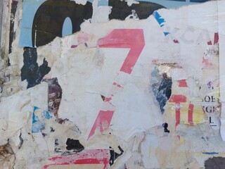 Fototapeta premium Torn and ripped street poster background, abstract and messy old paper art collage