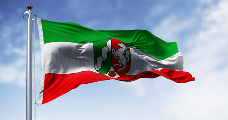 The flag of North Rhine-Westphalia waving in the wind on a clear day