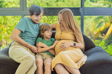 Cozy family time at home as pregnant mom, dad, and son enjoy shared moments on the sofa, creating heartwarming memories and cherishing their time together