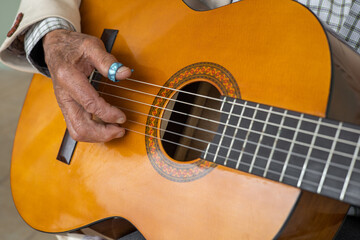 guitarist with string musical instrument, hands of a person with musical chords on guitar....