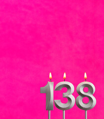 Candle number 138 - Birthday celebration on fuchsia background