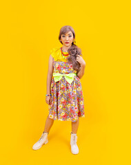 Asian hippie woman dress in 80s vintage fashion with colorful retro clothing while posing isolated on yellow background for fancy outfit party and pop culture concept