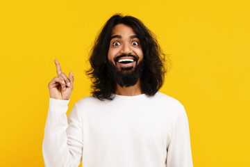 Enthusiastic Young Man Gesturing An Idea Against Bright Yellow Background