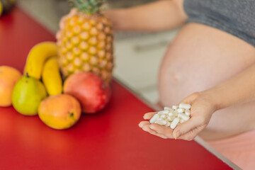 Balancing choices for optimal nutrition, a pregnant woman decides between the wholesome goodness of fresh fruits and the convenience of vitamin tablets, ensuring a well-rounded approach to her