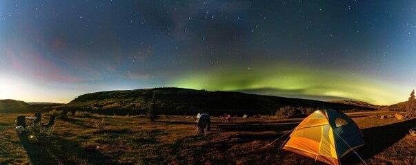 View of camping using a tent during the aurora phenomenon in the sky
