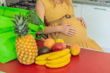 Exhausted but resilient, a pregnant woman feels fatigue after bringing home a sizable bag of groceries, showcasing her dedication to providing nourishing meals for herself and her baby