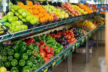 on shelves of supermarket are fresh and juicy fruits and vegetables, carefully harvested on farm plantations