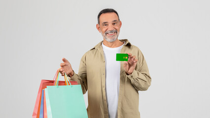Man Holding Shopping Bags and Credit Card
