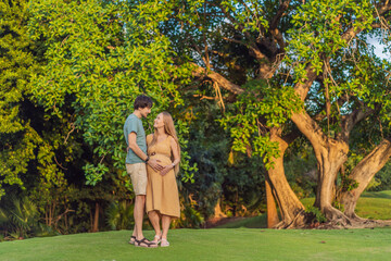 A blissful moment as a pregnant woman and her husband spend quality time together outdoors, savoring each other's company and enjoying the serenity of nature