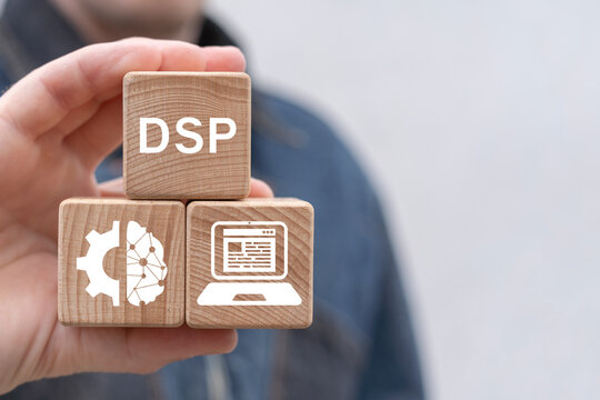 Man holding wooden blocks with icons sees abbreviation: DSP. Demand Side Platform ( DSP ) Business Technology Internet Network concept.