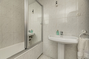 Antique bathroom with shower cabin in the bathtub with mirrored breastplates