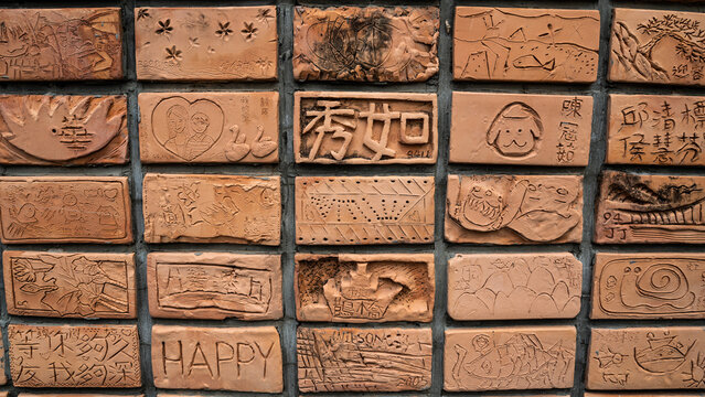 Carved handcrafted mud brick wall
