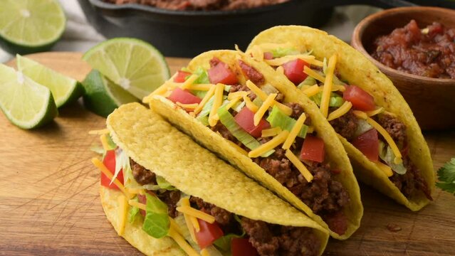 yellow hard shell tacos  on cutting board