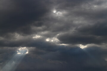 White grey cloudy day after rain with little bit ray of sun shining through the clouds, Sky nature background.