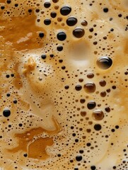 A macro photo of coffee texture with foam and bubbles.