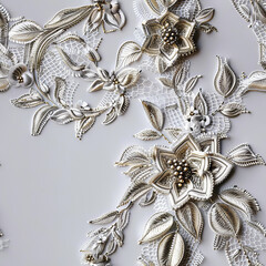 Seamless pattern of silver embroidery on white fabric