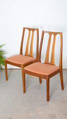 Vintage 1980s teak dining chairs. Mid-century modern style furniture with peach upholstery. ...