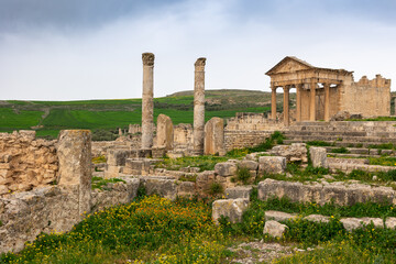 View of weathered remains of Capitol Temple in Dougga, historic Roman archaeological site in...