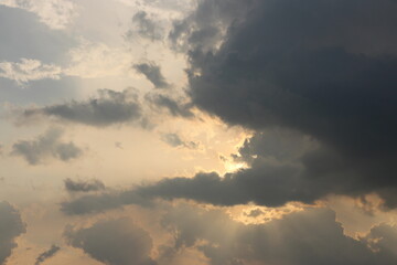 Sky blue and orange light of the sun through the clouds in the sky