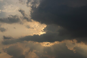 Sky blue and orange light of the sun through the clouds in the sky
