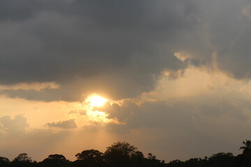 Sunset sky clouds in the Evening with Golden orange sunlight in golden hour, Dusk sky background.