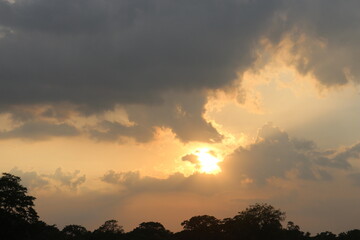 Sunset sky clouds in the Evening with Golden orange sunlight in golden hour, Dusk sky background.