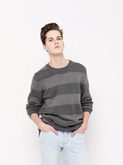 young handsome teenage hipster guy posing against white background isolated