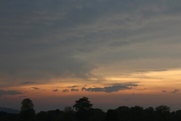 Beautiful Vivid sky painted by the sun leaving bright golden shades. Image of cloud sky on evening time. Evening Vivid sky with clouds.