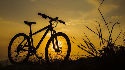 A bicycle is parked in a field with a beautiful sunset in the background. The bike is the only object in the scene, and it is a peaceful and serene moment captured in time