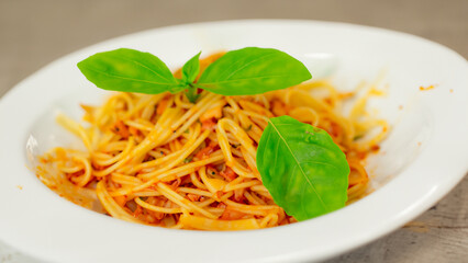 crispy basil leaves in white plate,Spicy pasta. Generative Ai
