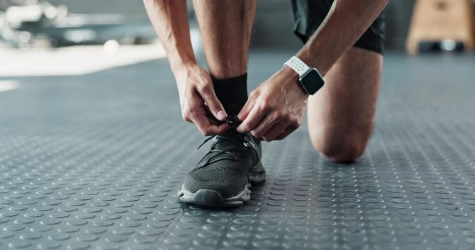 Runner, hands and tying shoes for exercise, training and workout or fitness with sneakers, fashion and getting ready. Person, athlete or jogger in closeup of laces, legs and feet for cardio at a gym