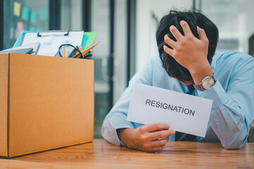 Young company employee stressed After resigning from work to find a new job , was fired by the...
