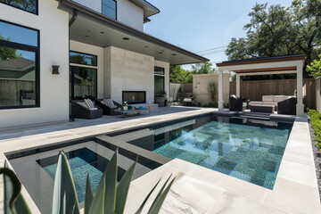 An image capturing the essence of a modern abode, with a backyard patio featuring a geometric pool design