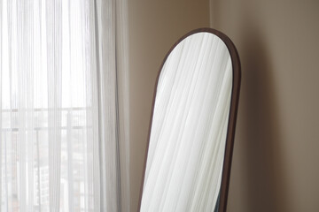round mirror handing on a wall .