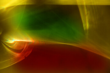 Red green yellow colored abstract background with light caustic effect. Light passes through a...