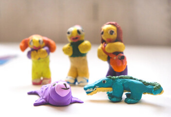 Child create funny animals, crocodile, alligator, seal, sea life from plasticine, family at the zoo,  colorful modeling clay. Education, playing with clay, sensory perception. Inspiration, imagination