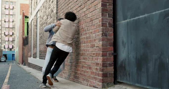 City, violence and men in street fight with conflict, battle and disagreement with aggression, punching and drama. Argument, bullying and angry friends in urban brawl in alley with frustrated danger