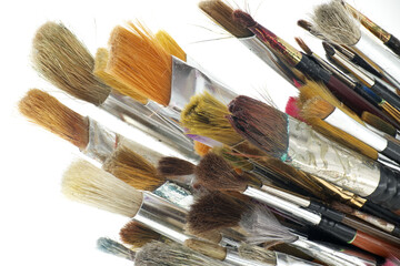 Various types and sizes of paintbrushes against a white