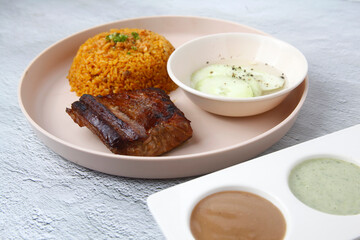Freshly prepared grilled tuna belly served with rice and dips