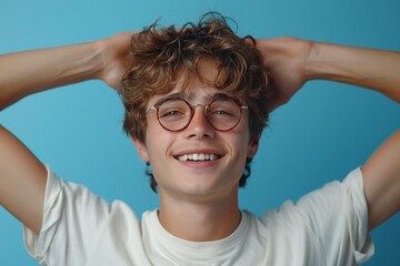 Portrait of a happy young man in glasses on a blue background