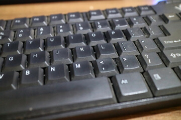 a black computer keyboard, slightly dusty