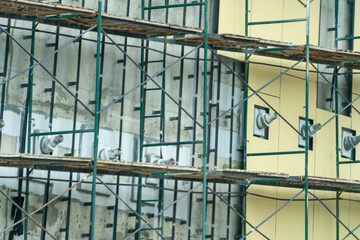 A building under construction with scaffolding and a lot of birds
