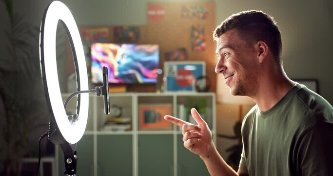Man, smartphone and ring light with talking or live streaming with content creation, vlogging and online broadcast. Social media blog, digital art and viral recording, audience and video in bedroom