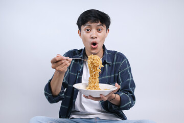 Shocked and Excited Young Man Eating Noodles, Pull Up The Noodles From The Plate 