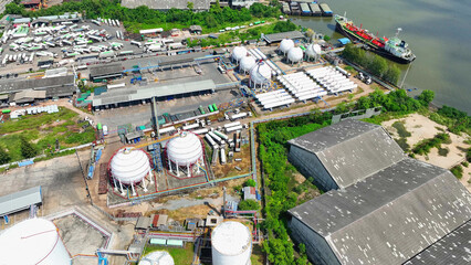 From above, the natural gas terminal looks like a complex maze of silver tanks and intricate...