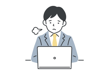 デスクワーク中にため息をつく男性