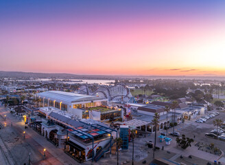 Aerial view of colorful sunrise sky over Mission Beach San Diego with Belmont Park Amusement park empty after a busy night