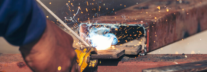 Banner Men hands wear protective glove Hot flame metal work cut fire iron workshop. Locksmith cut...